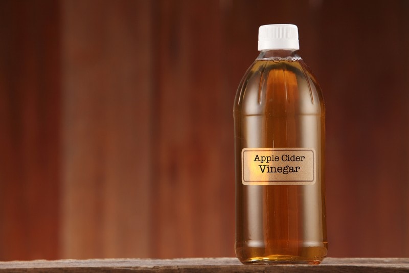 apple cider vinegar in a bottle focal point Shutterstock